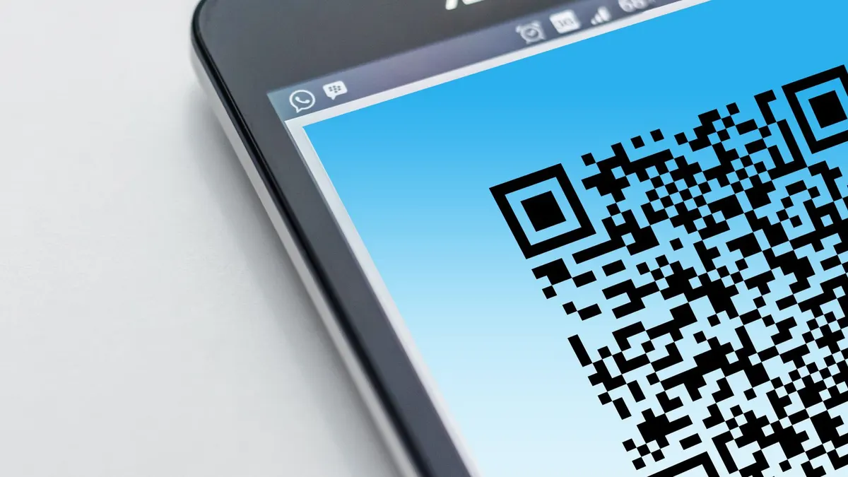 High-resolution close-up of a smartphone displaying a QR code on its screen.