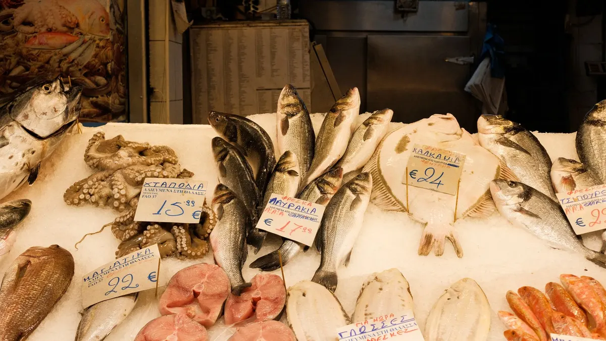 A variety of fresh fish showcased at a bustling market in Thessaloniki, Greece.