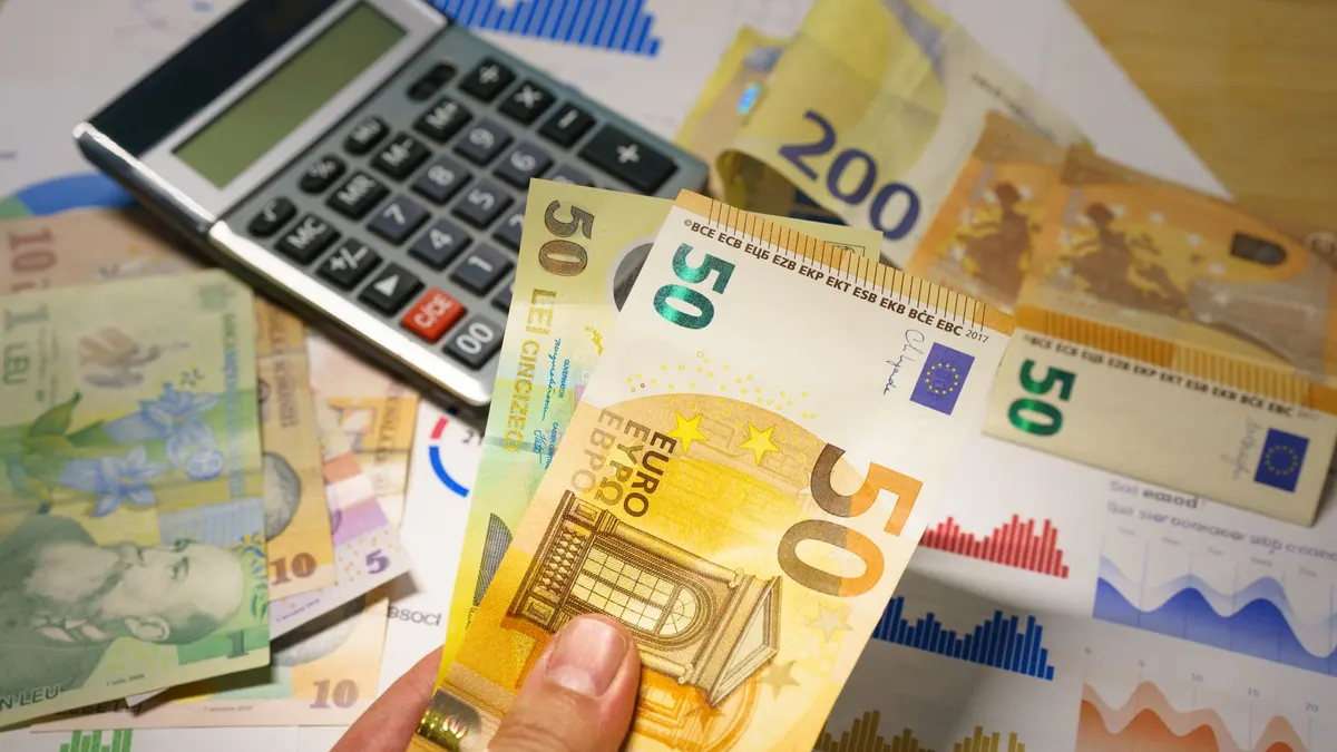 Euro and Romanian Lei currency with calculator on a financial desk setup.