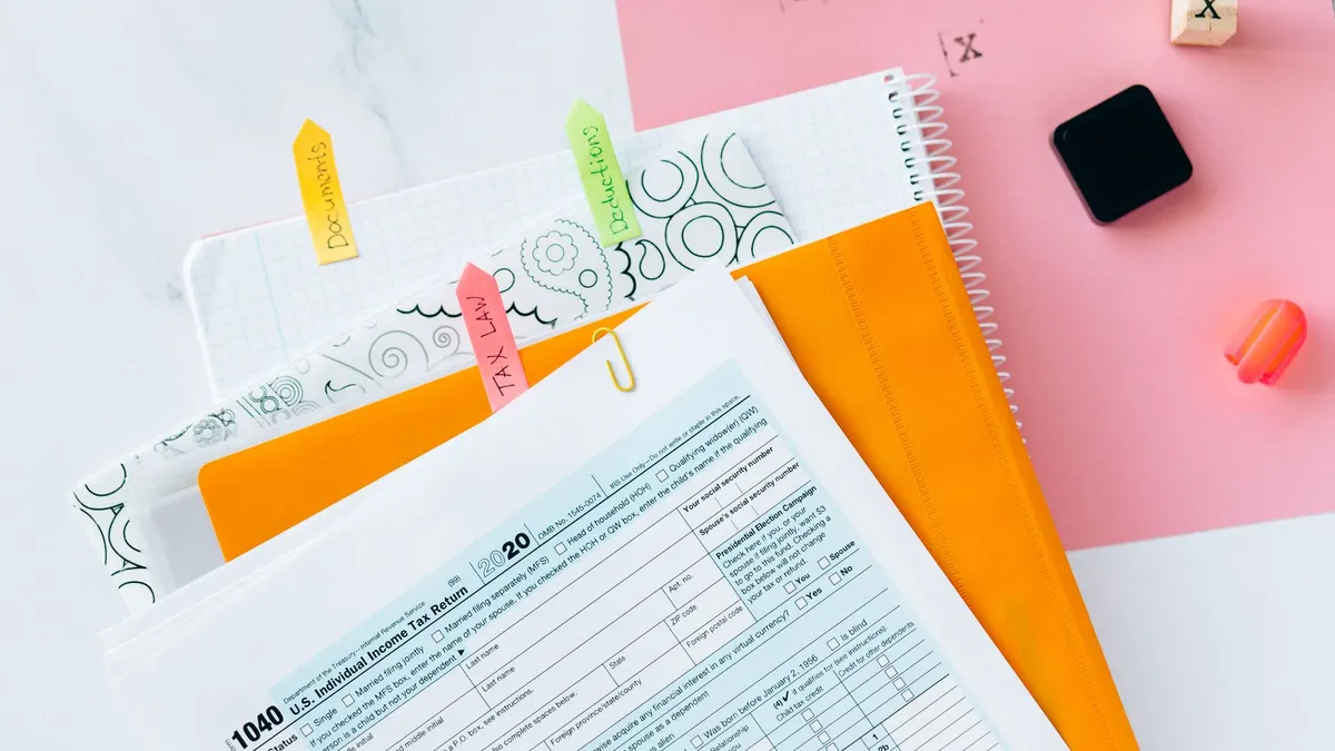 Overhead view of tax documents, forms, and organized work area for tax preparation.