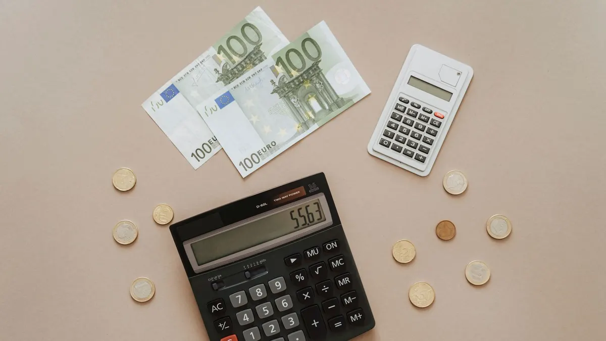 Flat lay of calculators and Euro currency, depicting financial calculations and budget management.