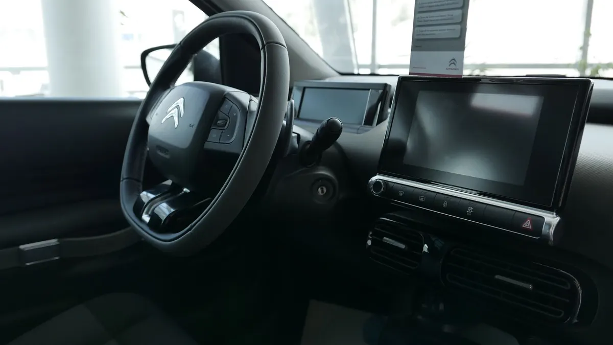 Explore the modern design and features of a Citroen car's dashboard and steering wheel.
