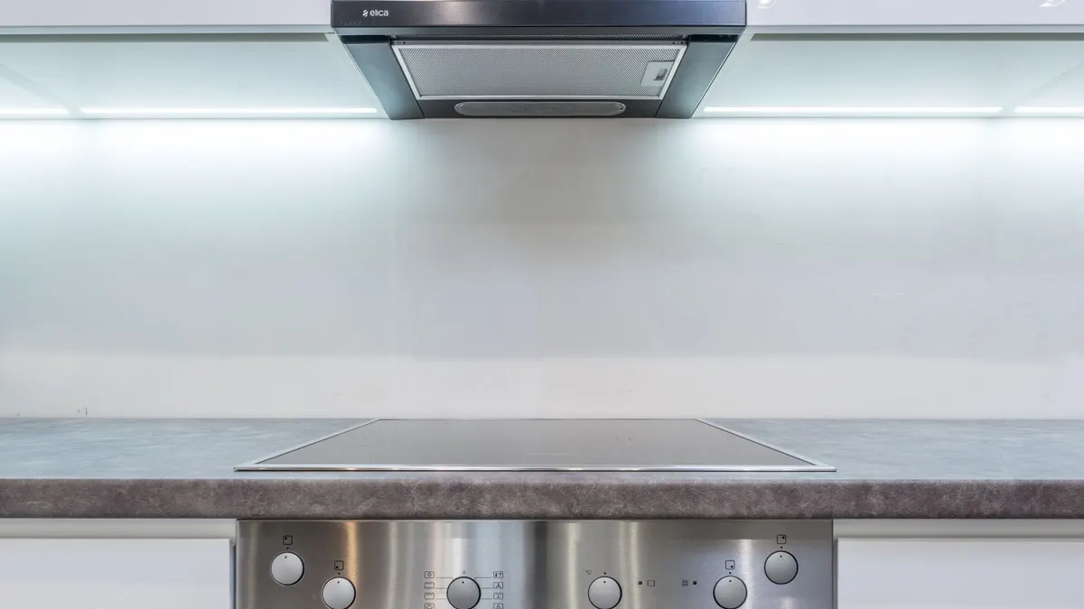 A sleek, modern kitchen with steel appliances and minimalist design.