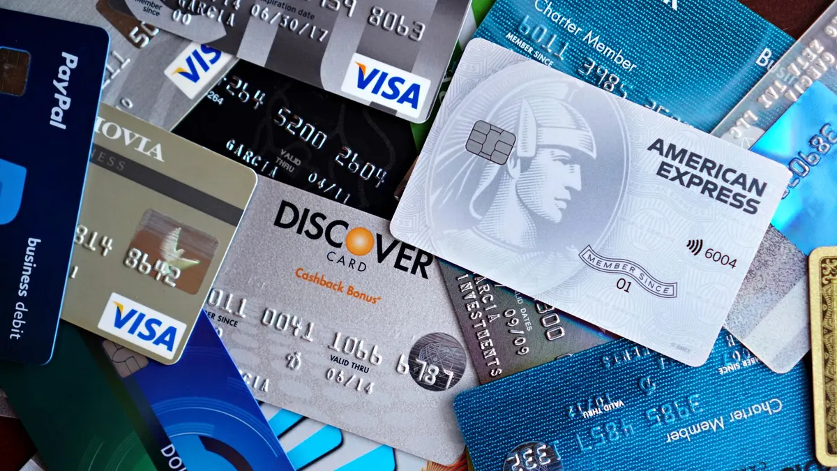 Close-up image of various credit cards including Visa, Mastercard, and American Express.
