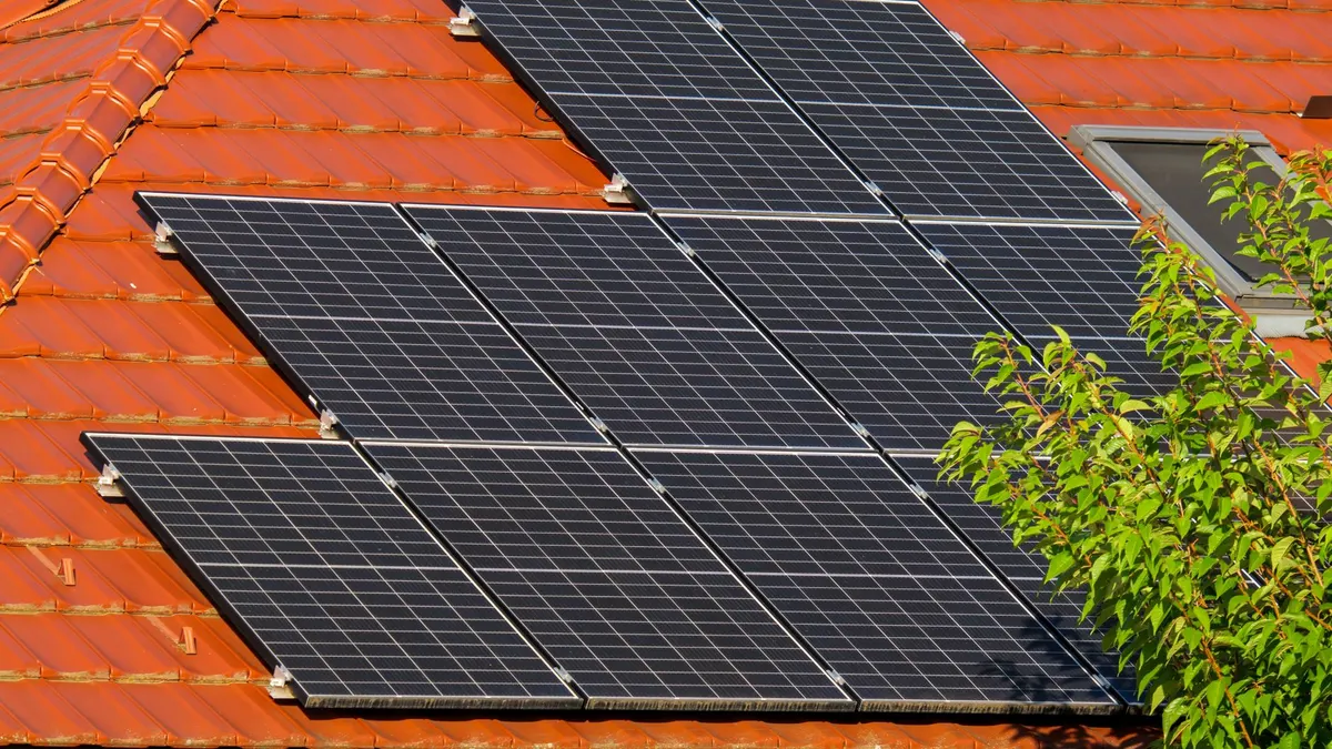 Close-up of solar panels on a red tiled roof in Croatia, highlighting renewable energy.